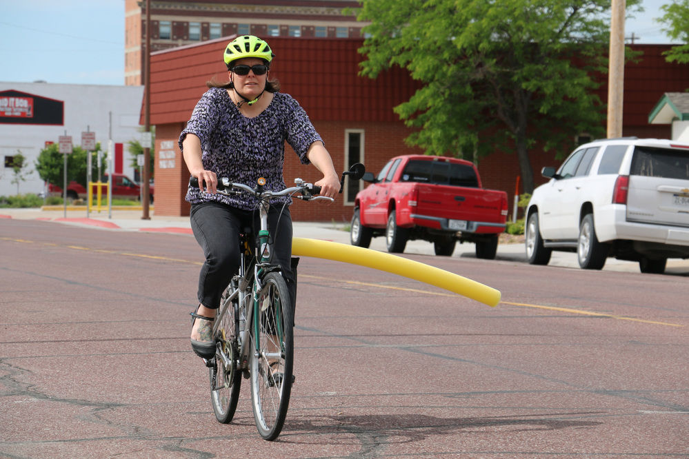 Katie Bradshaw bikes with pool noodle