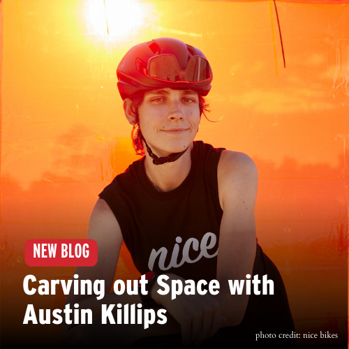 Austin Killips wearing a helmet and a soft smile against a sunny orange backdrop